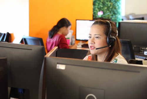 A female customer service agent with a headset