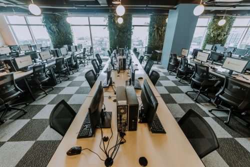 A Row of Computers, checkered floor in an Outsourcing Remote Office