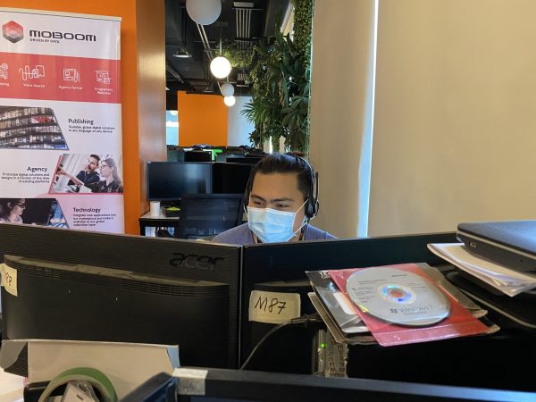 Male Outsourcing Remote Staff in Face Mask performing eCommerce Tasks