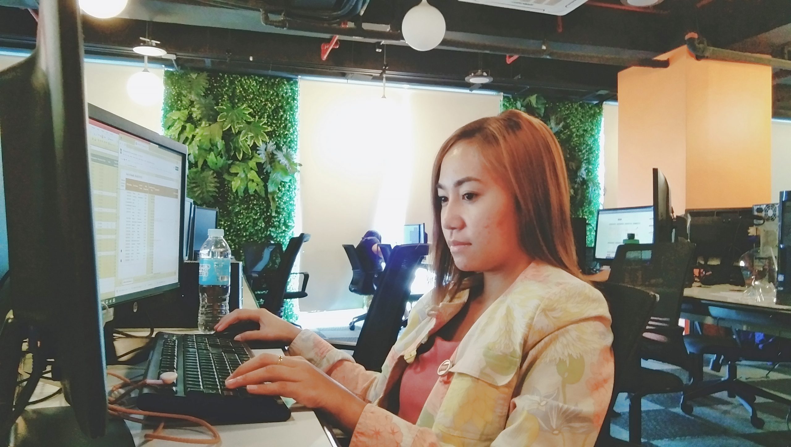 female outsourced bookkeeper working on a computer