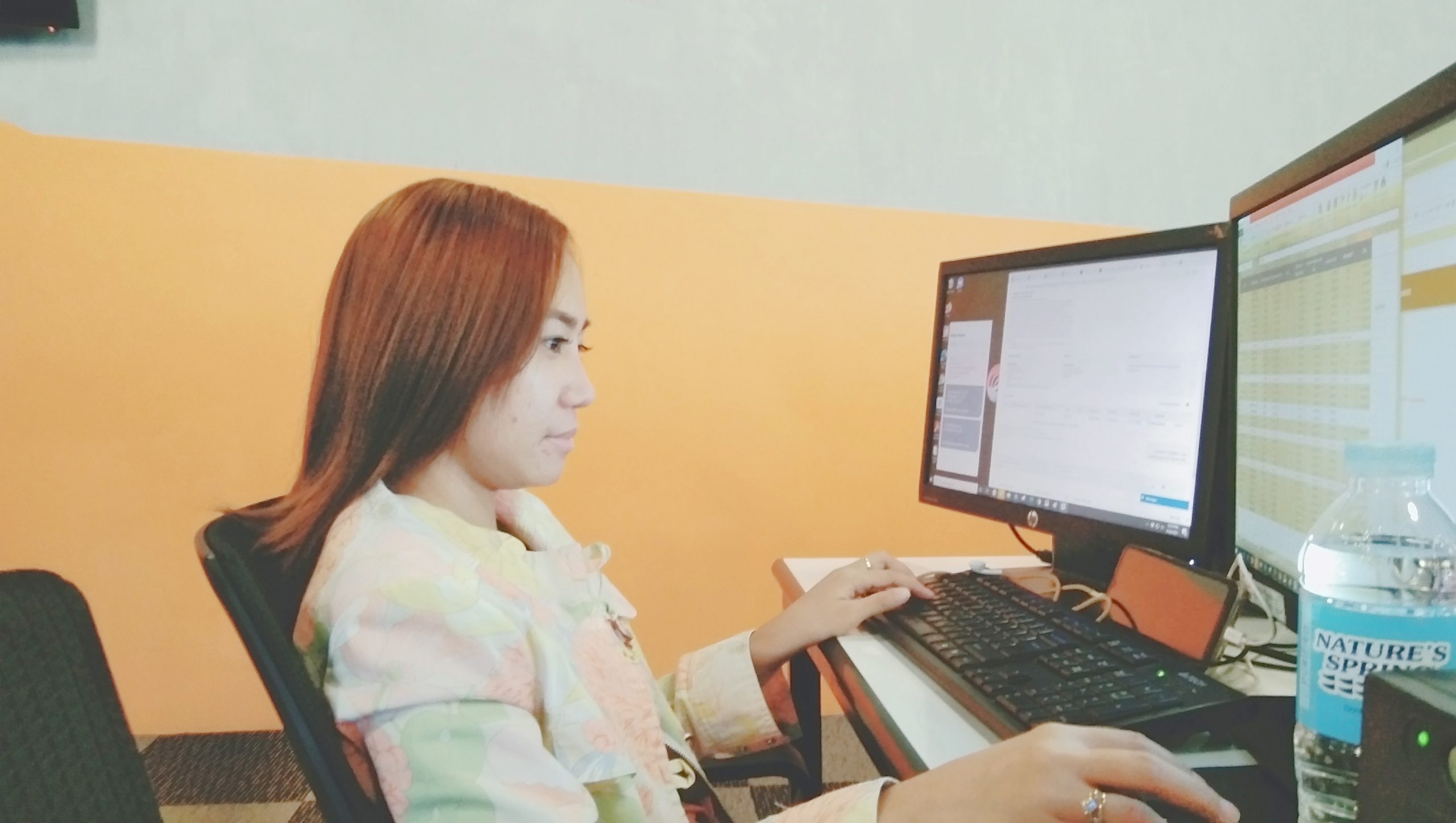 female outsourced bookkeeper working on a computer