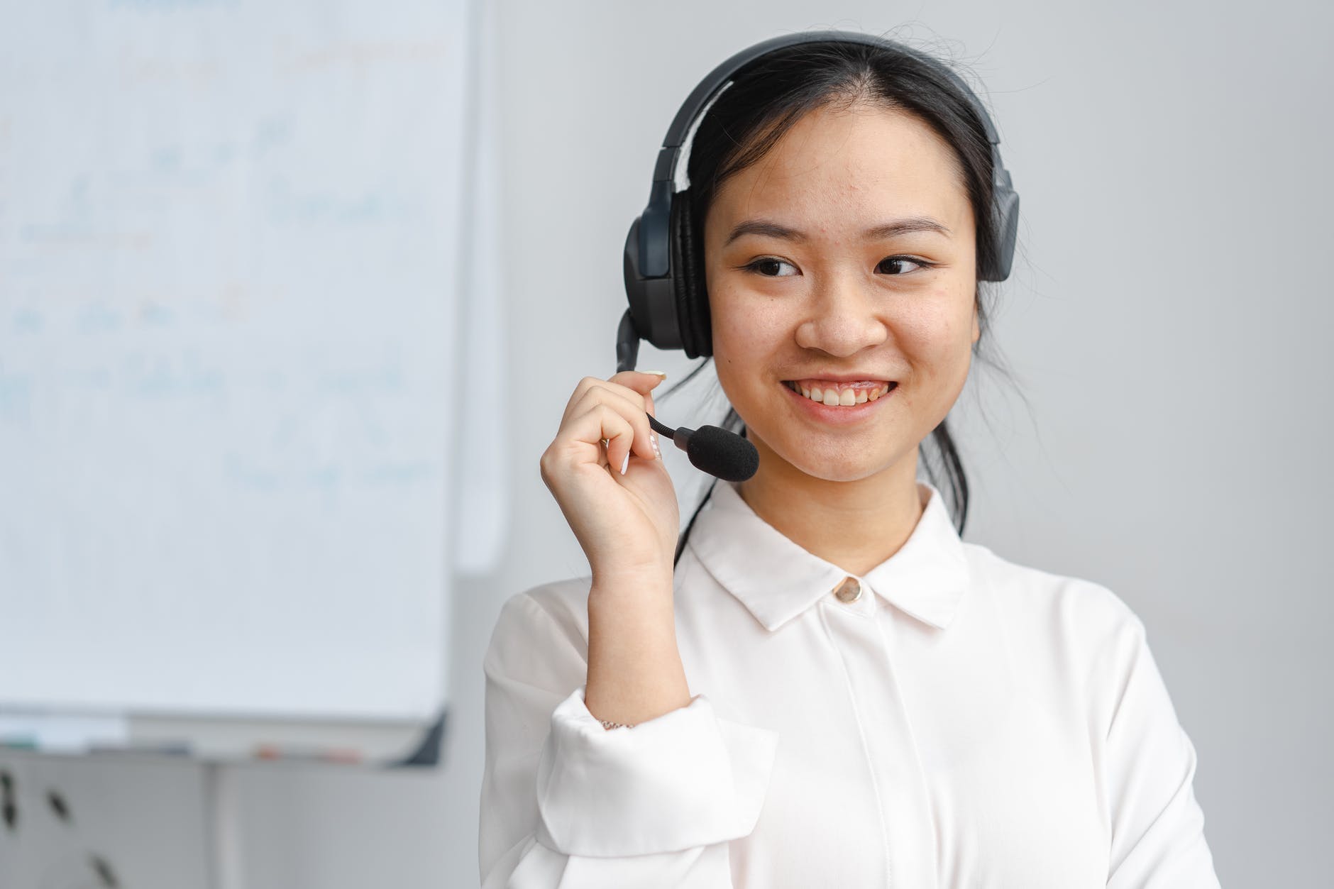 female virtual assistant with headset smiling