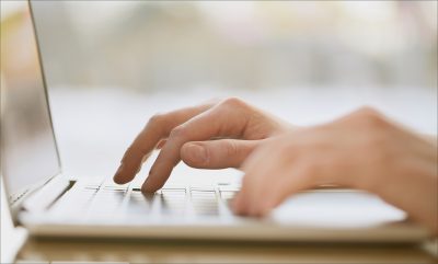 hands typing on a laptop